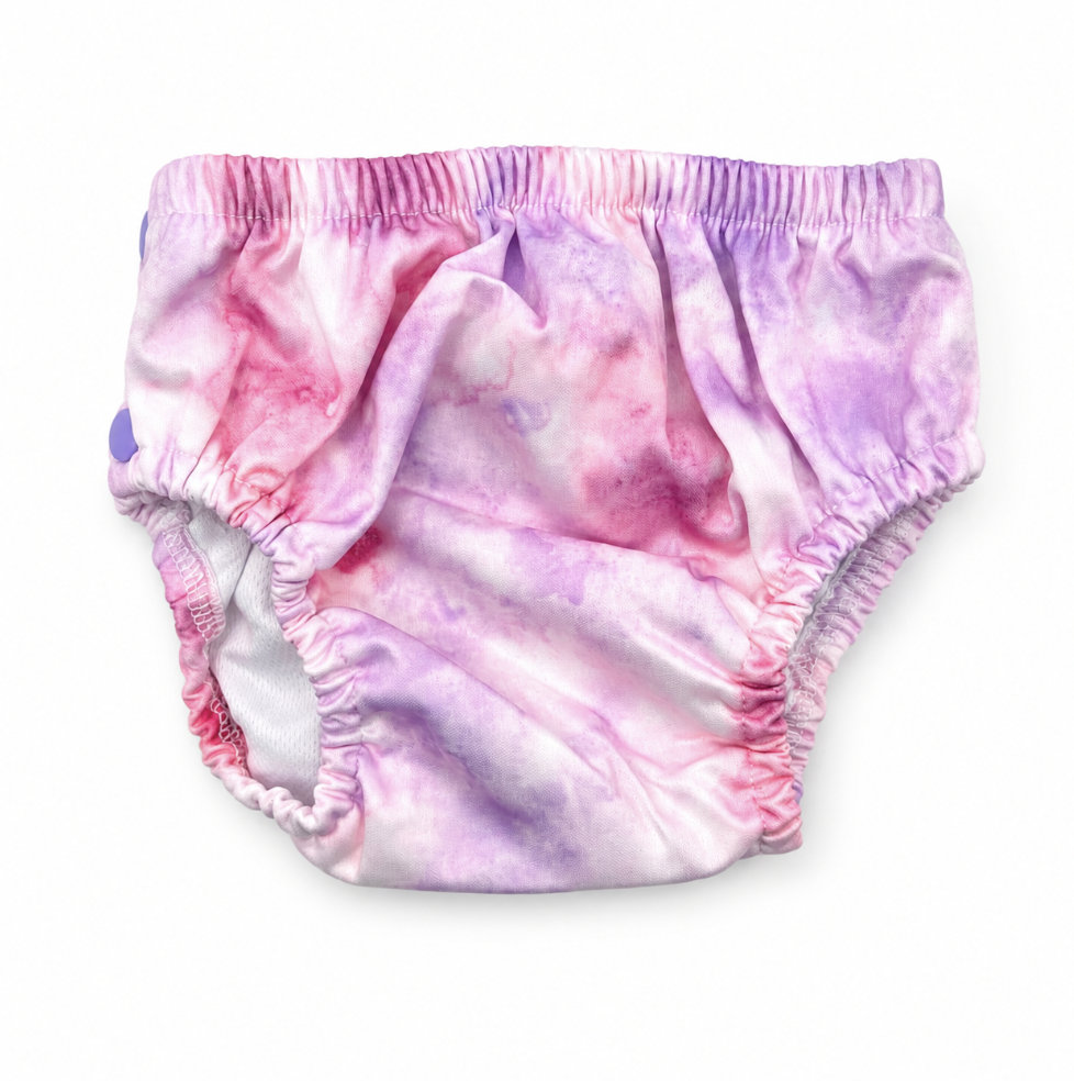 Fluffy Ducks Tie Dye Swim Nappy on a flat surface