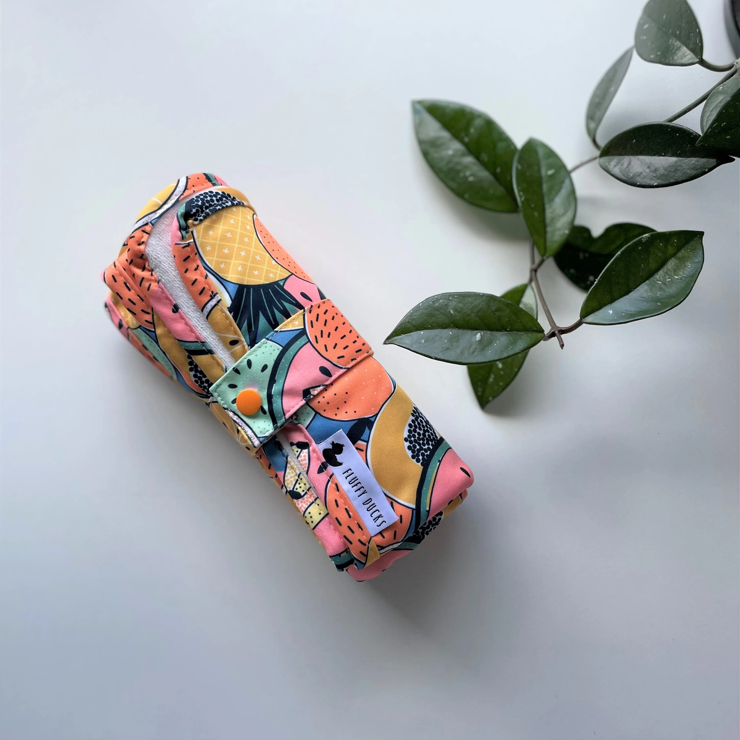 Fluffy Ducks Fruit Salad Change Mat rolled out on a surface