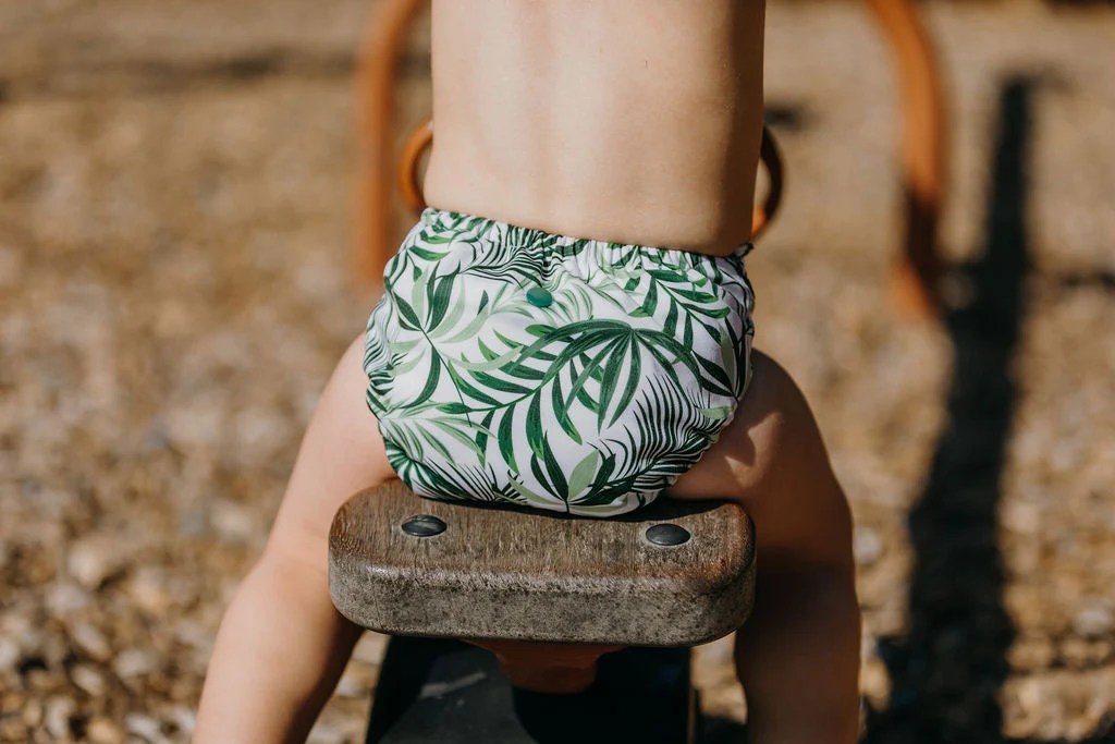 Close-up of Tropicana nappy showing snap buttons and bamboo inserts